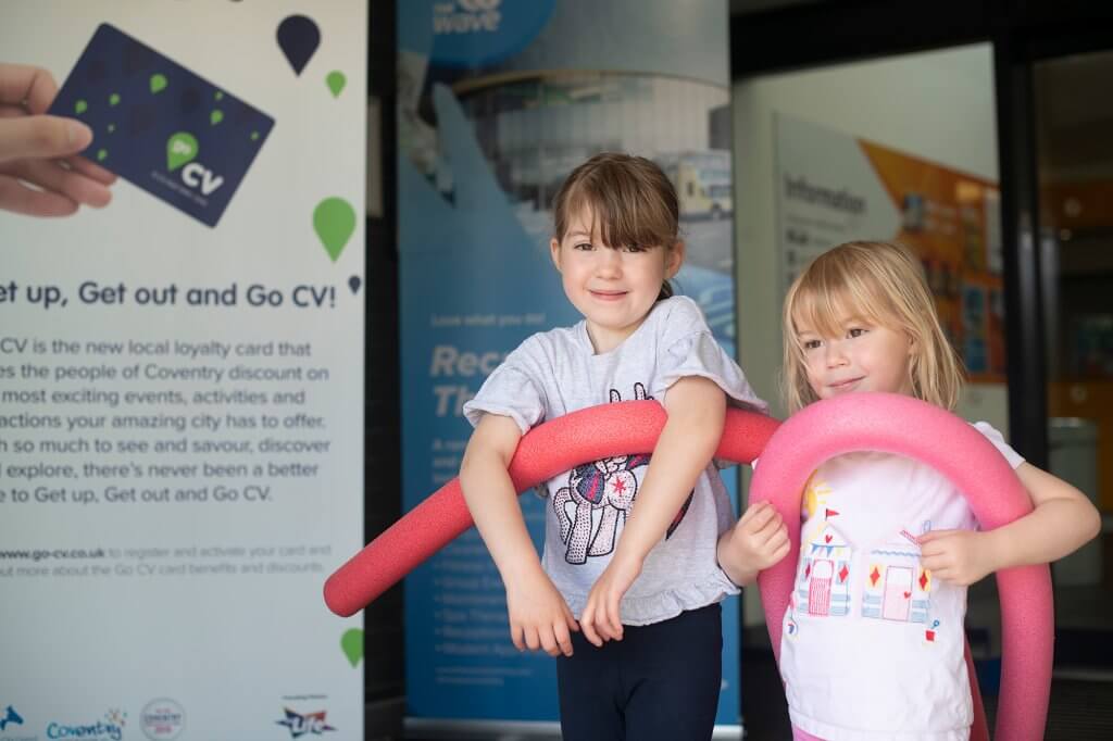 Two kids with floats standing at entrance to Xcel Leisure Centre