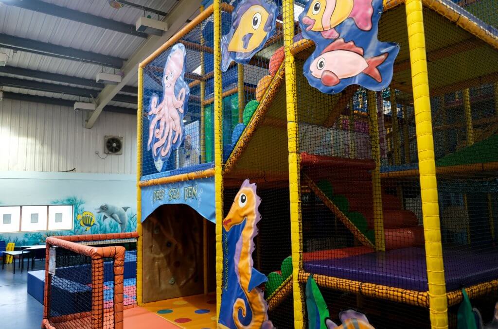Inside Centre AT7 Creche play area colourful soft play flooring and netting