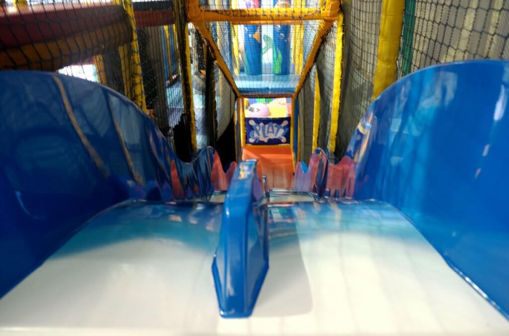 Inside Centre AT7 Creche play area colourful soft play flooring and long blue slide